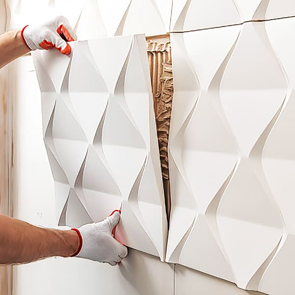 a worker installing wall decoration