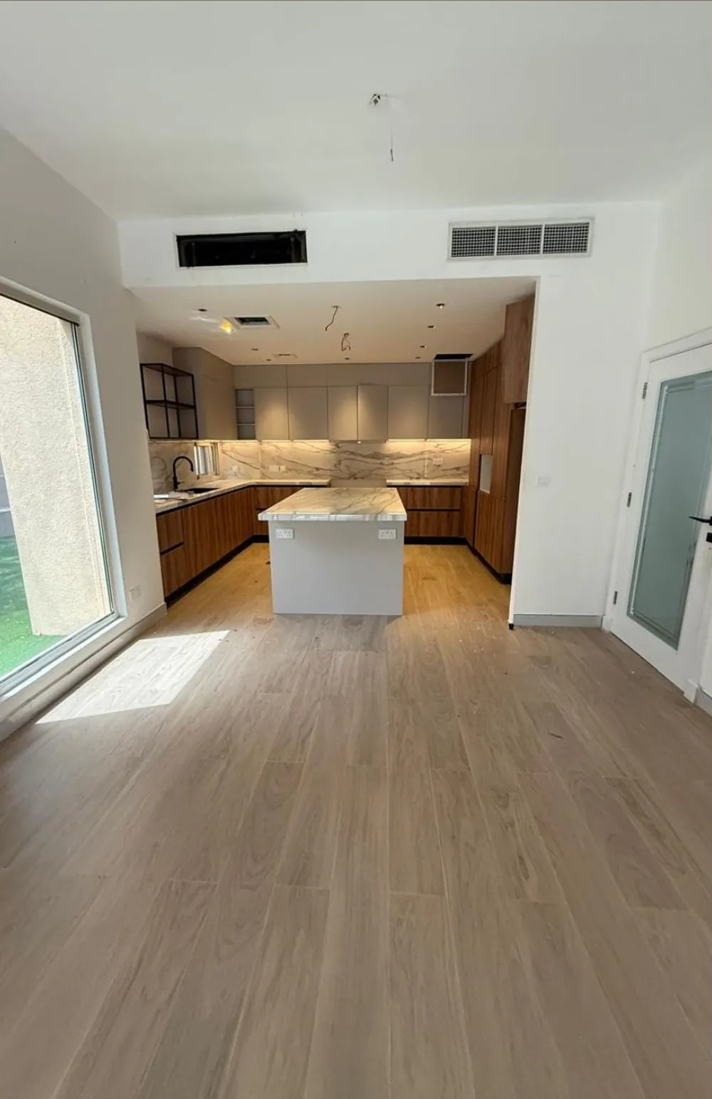 Before: open living area and kitchen in an Arabian Ranches villa before the renovation